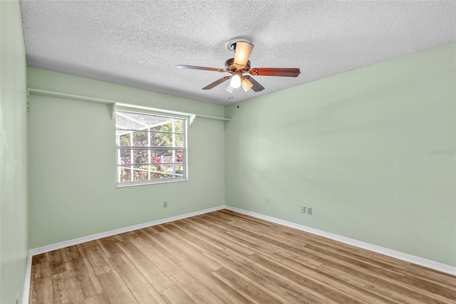 unfurnished room featuring a textured ceiling, baseboards, a ceiling fan, and wood finished floors