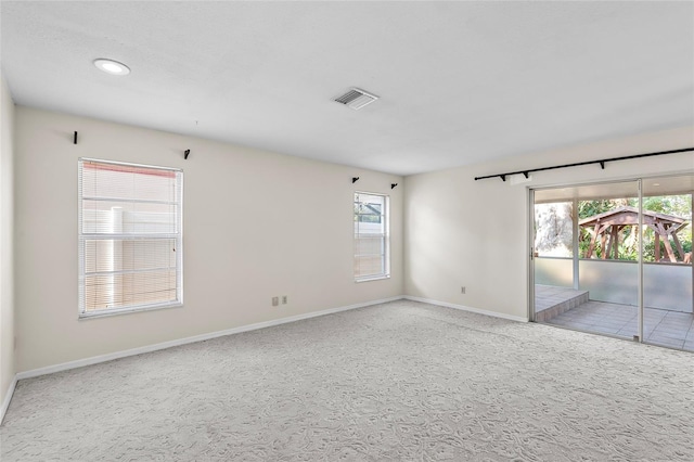 carpeted spare room featuring baseboards, recessed lighting, and visible vents