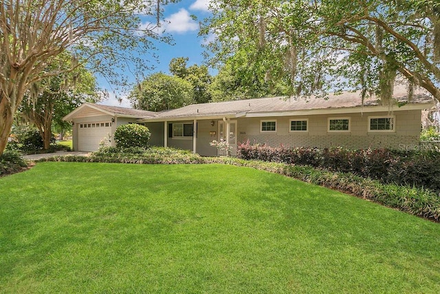 3605 Pershing Ave, Orlando, FL 32812 - ranch-style house with a front yard and an attached garage