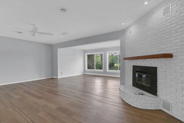 3605 Pershing Ave, Orlando, FL 32812 - unfurnished living room featuring a brick fireplace, wood finished floors, a ceiling fan, baseboards, and recessed lighting