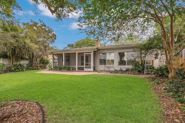 3605 Pershing Ave, Orlando, FL 32812 - rear view of property with a sunroom and a chimney
