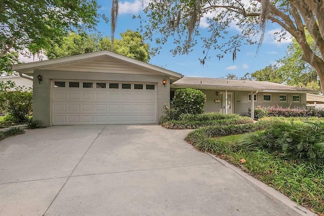 3605 Pershing Ave, Orlando, FL 32812 - ranch-style home featuring concrete driveway and a garage