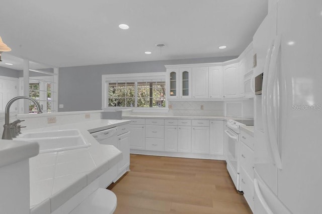 3605 Pershing Ave, Orlando, FL 32812 - kitchen featuring white appliances, a sink, tile counters, healthy amount of natural light, and recessed lighting