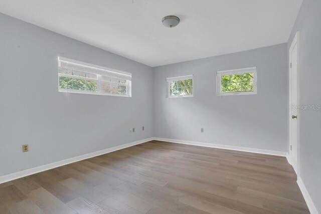 3605 Pershing Ave, Orlando, FL 32812 - spare room with wood finished floors and baseboards