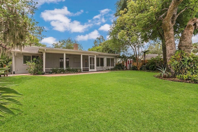 3605 Pershing Ave, Orlando, FL 32812 - rear view of house featuring a chimney and a sunroom