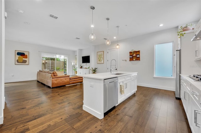 kitchen featuring a sink, stainless steel appliances, visible vents, white cabinetry, and light countertops