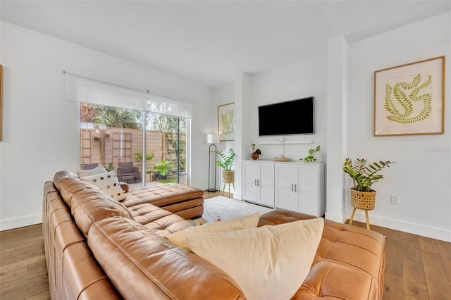 living room with baseboards and hardwood / wood-style flooring