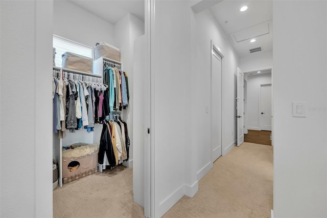 hallway featuring baseboards, recessed lighting, visible vents, and carpet