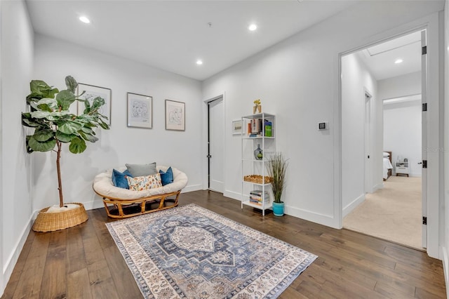 sitting room featuring baseboards, hardwood / wood-style floors, and recessed lighting