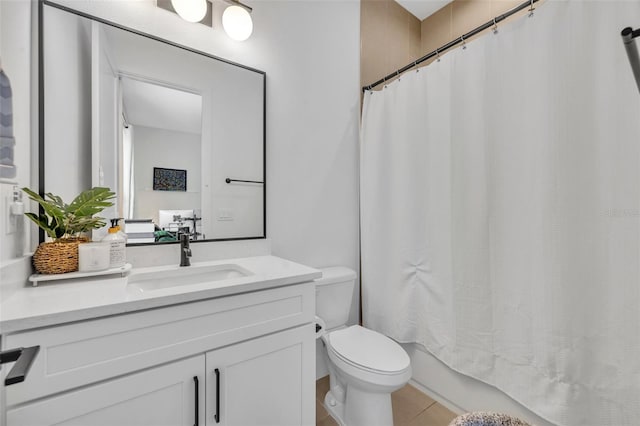 bathroom with toilet, tile patterned flooring, and vanity