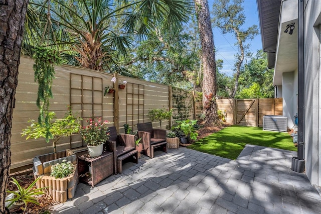 view of patio / terrace with a fenced backyard and central AC