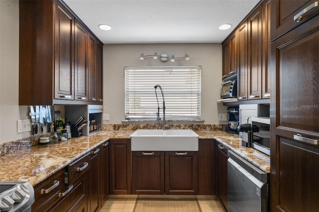 4118 Teriwood Ave, Orlando, FL 32812 - kitchen featuring dark brown cabinets, light stone counters, a sink, stainless steel appliances, and light tile patterned floors