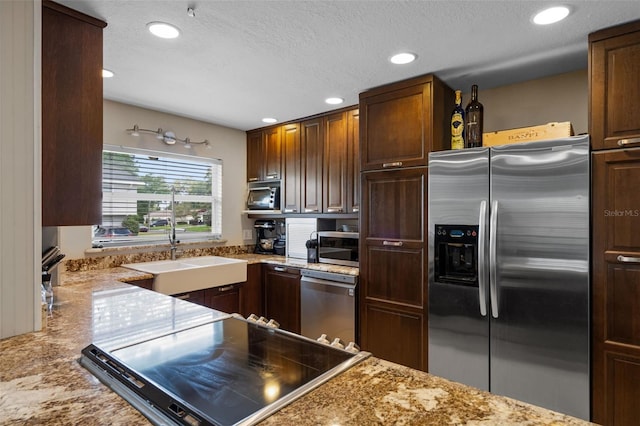 4118 Teriwood Ave, Orlando, FL 32812 - kitchen featuring light stone countertops, recessed lighting, a textured ceiling, a sink, and stainless steel appliances