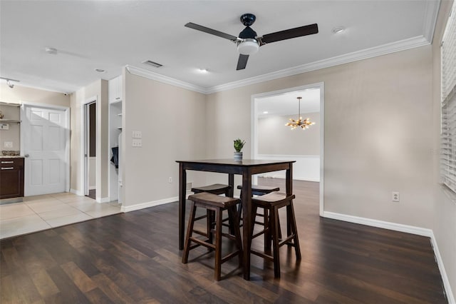 4118 Teriwood Ave, Orlando, FL 32812 - dining space featuring baseboards, ceiling fan with notable chandelier, wood finished floors, and visible vents