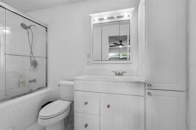 4118 Teriwood Ave, Orlando, FL 32812 - full bathroom featuring shower / bath combination with glass door, toilet, a ceiling fan, and vanity