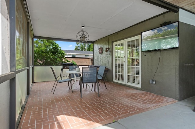 4118 Teriwood Ave, Orlando, FL 32812 - sunroom featuring a healthy amount of sunlight, outdoor dining space, and a notable chandelier