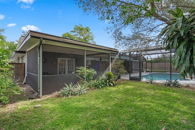 4118 Teriwood Ave, Orlando, FL 32812 - rear view of property featuring fence, a fenced in pool, a sunroom, glass enclosure, and a yard