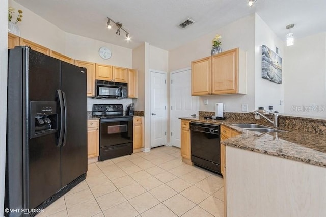kitchen featuring a sink, light brown cabinets, stone counters, visible vents, and black appliances