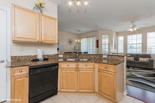 kitchen featuring light brown cabinetry, a sink, black dishwasher, a peninsula, and light tile patterned floors