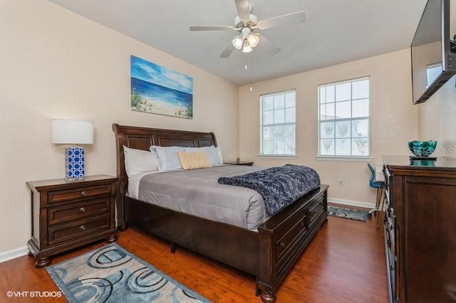 bedroom with baseboards, a ceiling fan, and wood finished floors