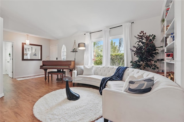 living room with baseboards and light wood-style flooring