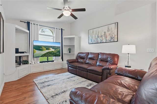 living area featuring a ceiling fan and wood finished floors