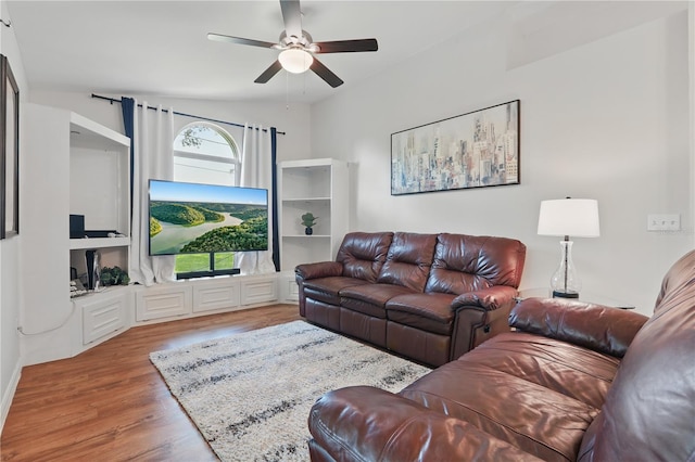 living room featuring a ceiling fan and wood finished floors