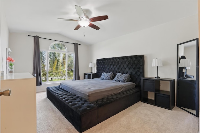 carpeted bedroom with a ceiling fan and lofted ceiling