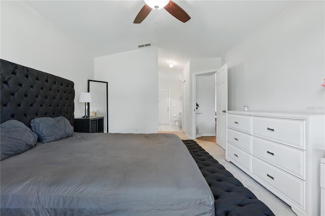 bedroom with ensuite bathroom, ceiling fan, light carpet, and visible vents