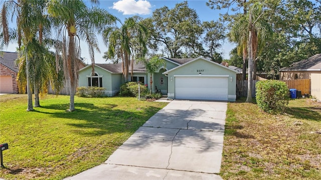 ranch-style house with fence, a front lawn, a garage, stucco siding, and driveway