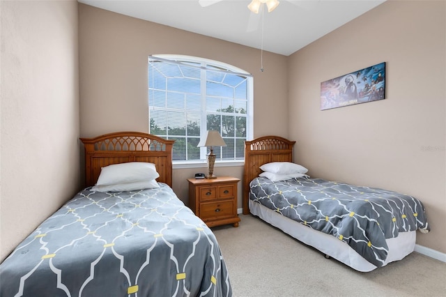 carpeted bedroom featuring a ceiling fan and baseboards