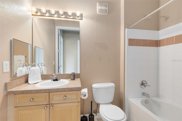 full bathroom featuring toilet, shower / bath combination, a textured wall, and vanity