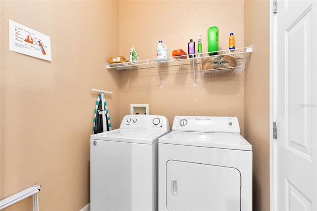 laundry room featuring washing machine and clothes dryer