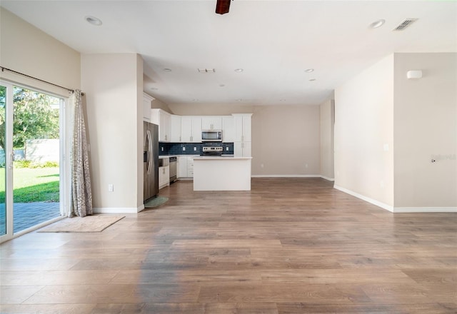 unfurnished living room featuring baseboards, recessed lighting, visible vents, and light wood-style flooring