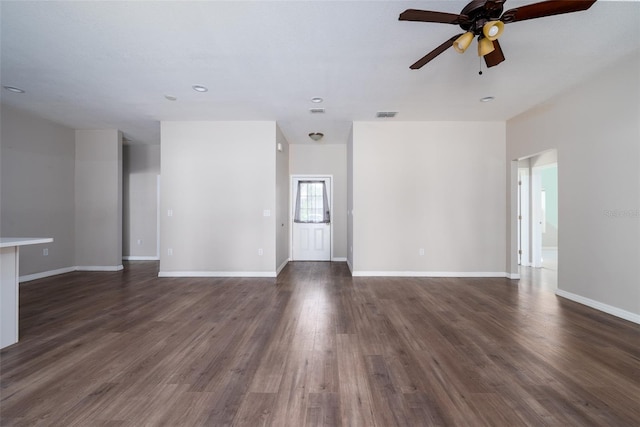 unfurnished living room featuring recessed lighting, ceiling fan, dark wood-type flooring, visible vents, and baseboards
