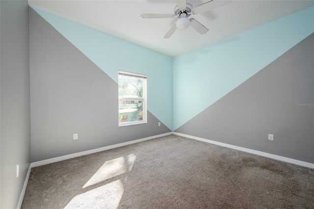 unfurnished room featuring a ceiling fan, carpet flooring, and baseboards