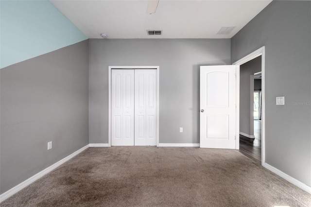 unfurnished bedroom with baseboards, visible vents, a closet, and carpet flooring
