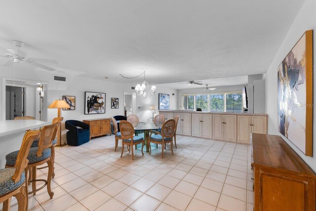 6330 Masters Blvd Unit N4, Orlando, FL 32819 - dining room featuring a ceiling fan, light tile patterned floors, and a chandelier