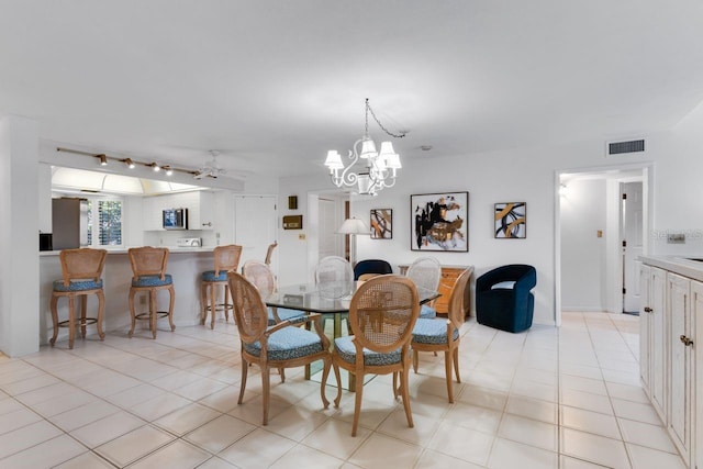 6330 Masters Blvd Unit N4, Orlando, FL 32819 - dining room featuring a chandelier and rail lighting