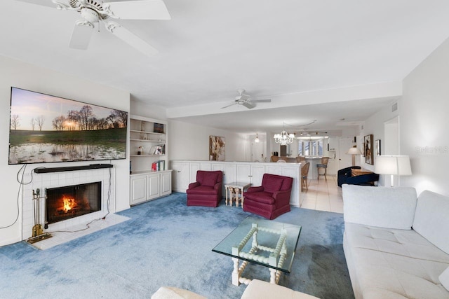 6330 Masters Blvd Unit N4, Orlando, FL 32819 - carpeted living area featuring a ceiling fan, a fireplace with flush hearth, and a chandelier