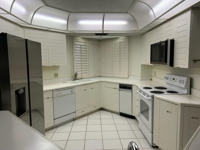6330 Masters Blvd Unit N4, Orlando, FL 32819 - kitchen with white appliances, light countertops, and light tile patterned flooring