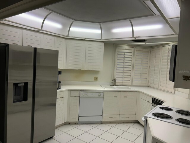 6330 Masters Blvd Unit N4, Orlando, FL 32819 - kitchen with white appliances, light countertops, and light tile patterned floors