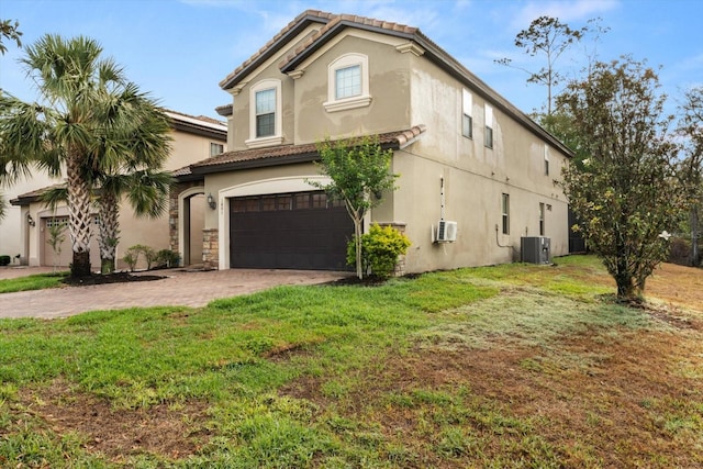 1801 Nice Ct, Kissimmee, FL 34747 - view of side of property featuring a garage, stucco siding, a lawn, driveway, and a tile roof