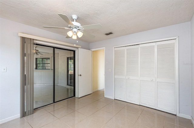 unfurnished bedroom featuring visible vents, baseboards, ceiling fan, and light tile patterned floors