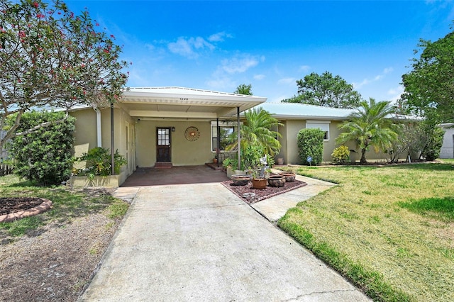 1208 Duke Way, Cocoa, FL 32922 - ranch-style house featuring a carport, stucco siding, a front yard, and concrete driveway