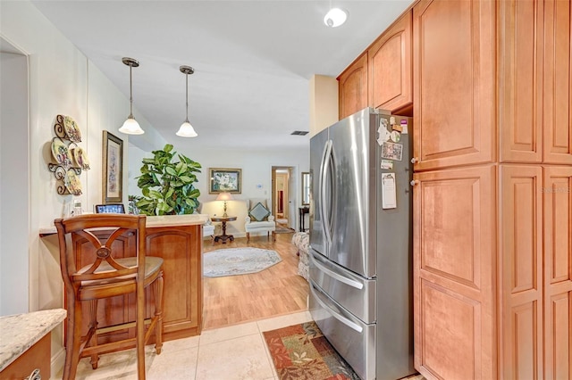 1208 Duke Way, Cocoa, FL 32922 - kitchen featuring a peninsula, freestanding refrigerator, a breakfast bar, pendant lighting, and open floor plan