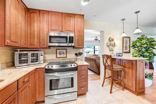 1208 Duke Way, Cocoa, FL 32922 - kitchen featuring a toaster, appliances with stainless steel finishes, and brown cabinetry