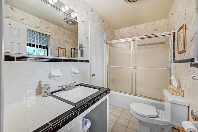 1208 Duke Way, Cocoa, FL 32922 - full bathroom featuring toilet, tile walls, bath / shower combo with glass door, and tile patterned flooring