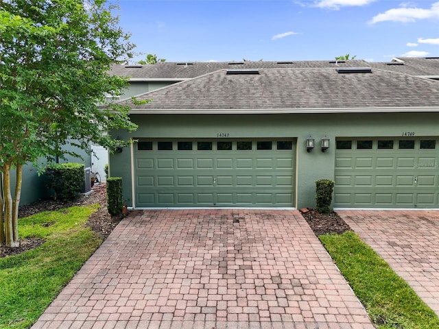 garage featuring decorative driveway