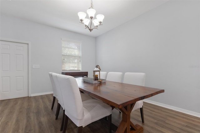 dining room featuring baseboards, a chandelier, and wood finished floors